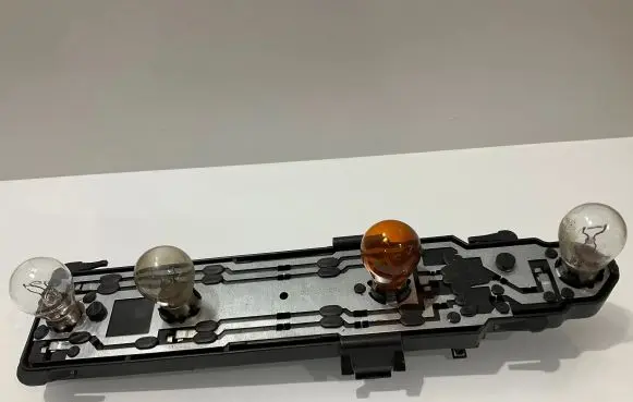 Tail light bulb cover holder