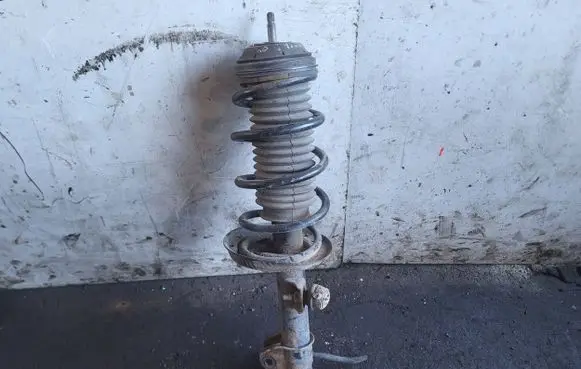 Opel Corsa D Front shock absorber with coil spring 13214358