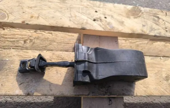 Front door check strap stopper