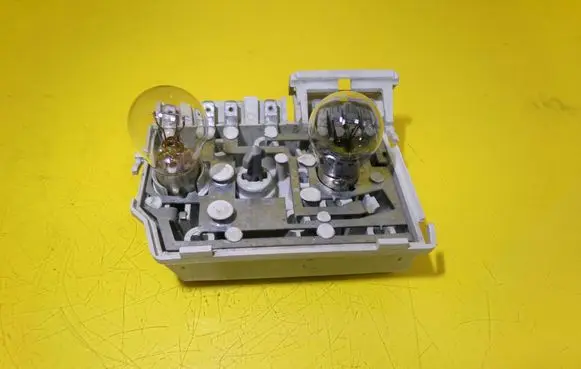 Tail light bulb cover holder
