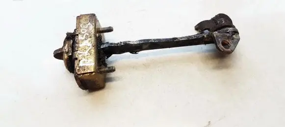 Front door check strap stopper