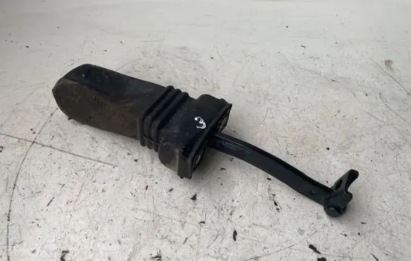 Front door check strap stopper