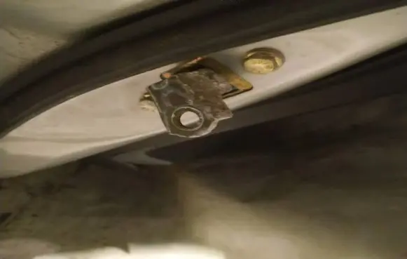 Front door check strap stopper