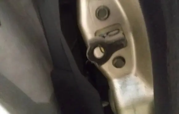 Front door check strap stopper