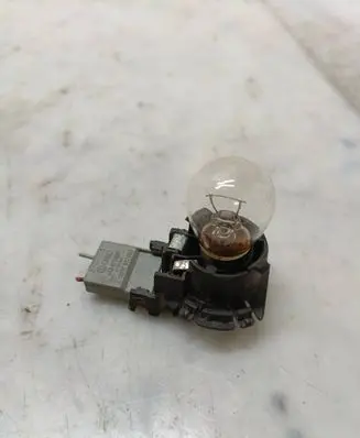 Tail light bulb cover holder