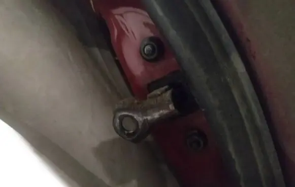 Front door check strap stopper