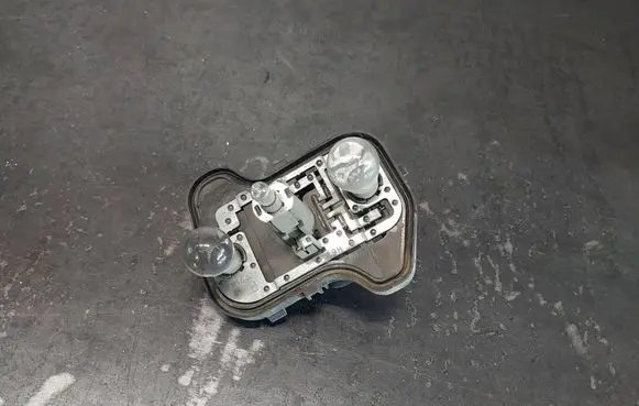 Tail light bulb cover holder