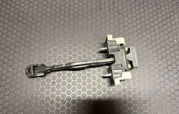 Front door check strap stopper