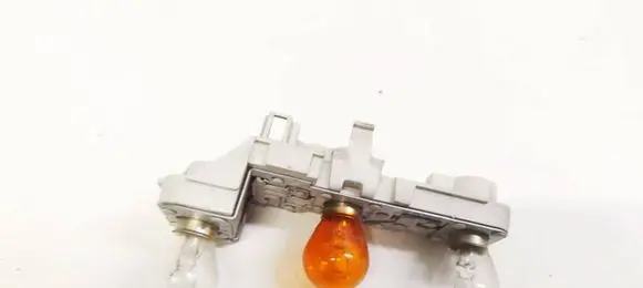 Tail light bulb cover holder