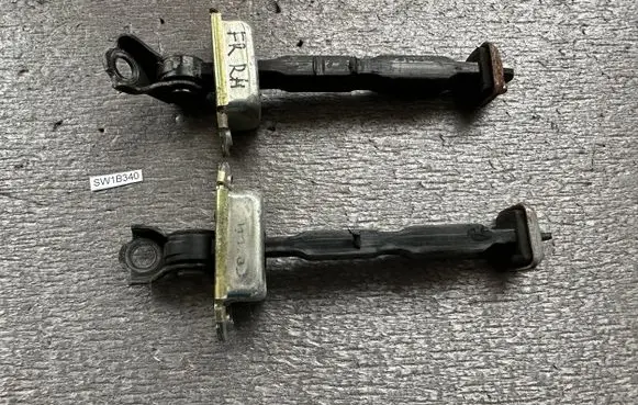 Front door check strap stopper