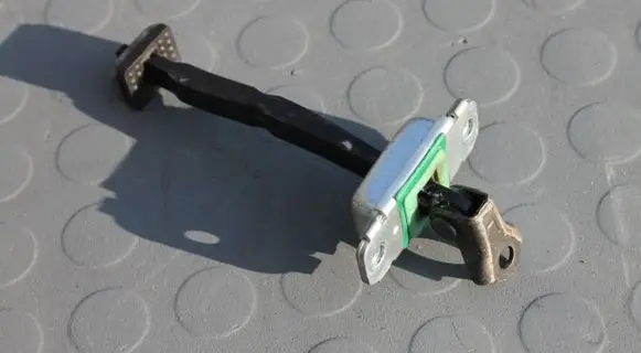 Front door check strap stopper