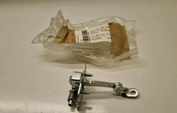 Front door check strap stopper
