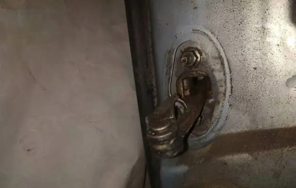 Front door check strap stopper