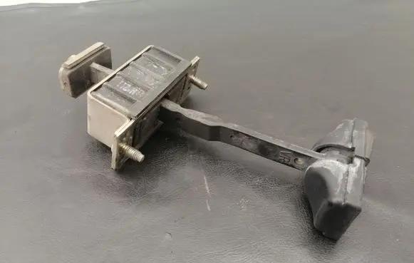 Front door check strap stopper
