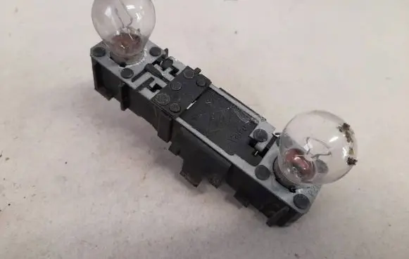 Tail light bulb cover holder