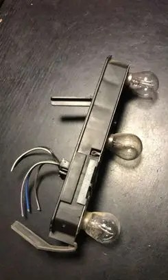 Tail light bulb cover holder