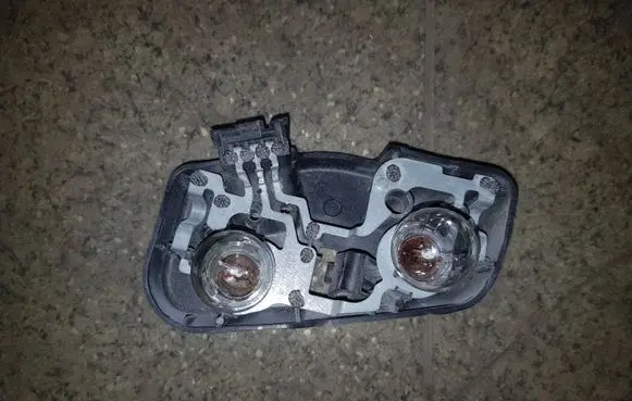 Tail light bulb cover holder