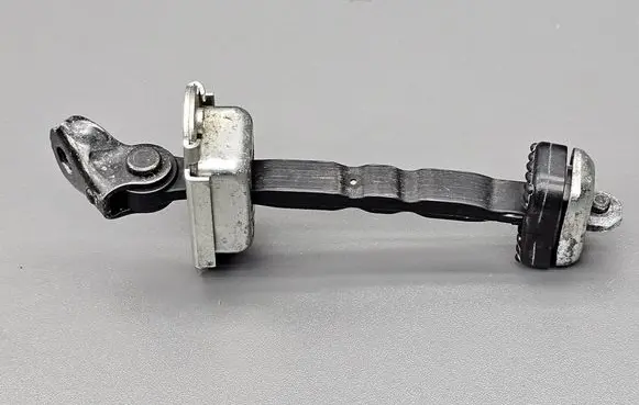 Front door check strap stopper