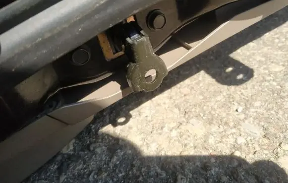 Front door check strap stopper