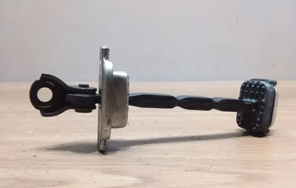 Front door check strap stopper