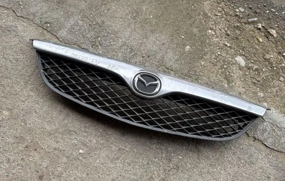 Mazda 626 Front bumper upper radiator grill GE4V50719
