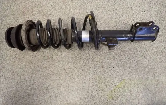 Suzuki Swift I Front shock absorber with coil spring
