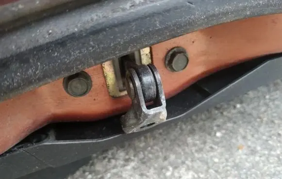 Front door check strap stopper