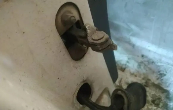 Front door check strap stopper