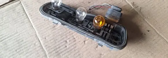 Tail light bulb cover holder