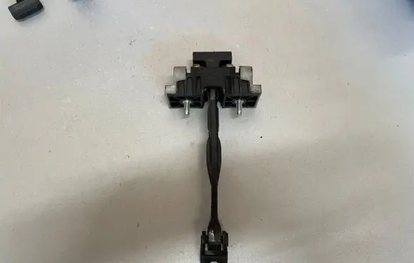 Front door check strap stopper