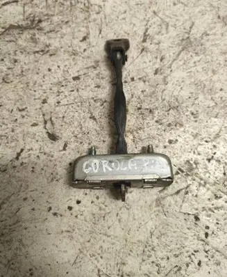 Front door check strap stopper
