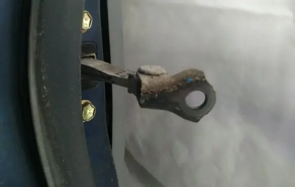 Front door check strap stopper