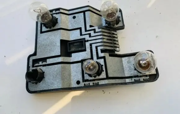 Tail light bulb cover holder