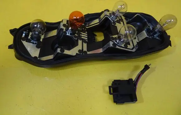 Tail light bulb cover holder