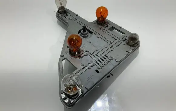 Tail light bulb cover holder