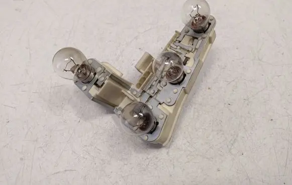 Tail light bulb cover holder