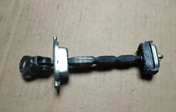 Front door check strap stopper