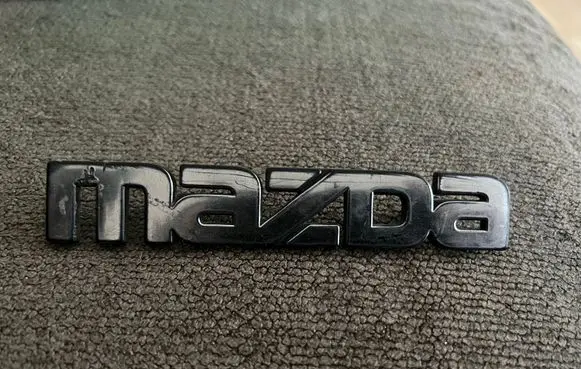 Mazda 323 Manufacturers badge/model letters 