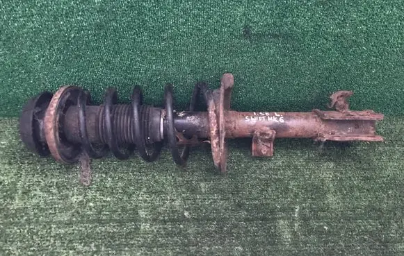 Suzuki Swift I Front shock absorber with coil spring