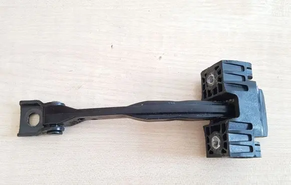 Front door check strap stopper