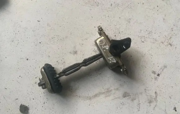 Front door check strap stopper