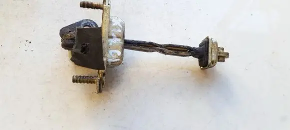 Front door check strap stopper