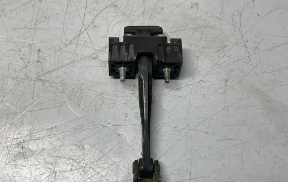 Front door check strap stopper