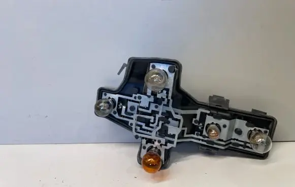 Tail light bulb cover holder