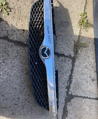Mazda 323 Front bumper upper radiator grill