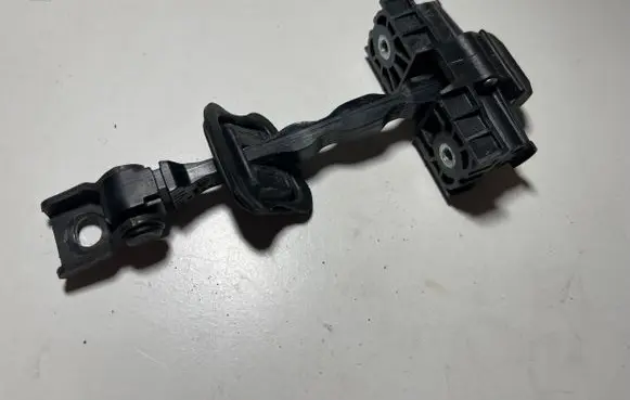 Front door check strap stopper