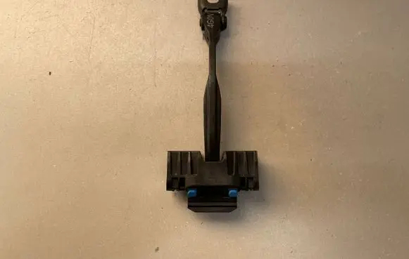 Front door check strap stopper