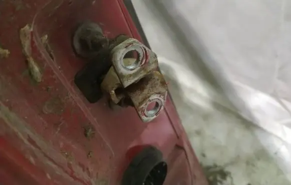 Front door check strap stopper