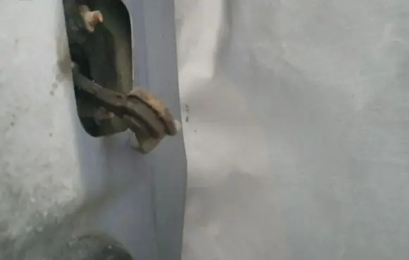 Front door check strap stopper