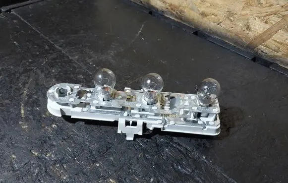 Tail light bulb cover holder